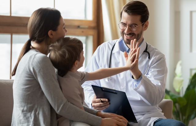 Happy doc with mother & child